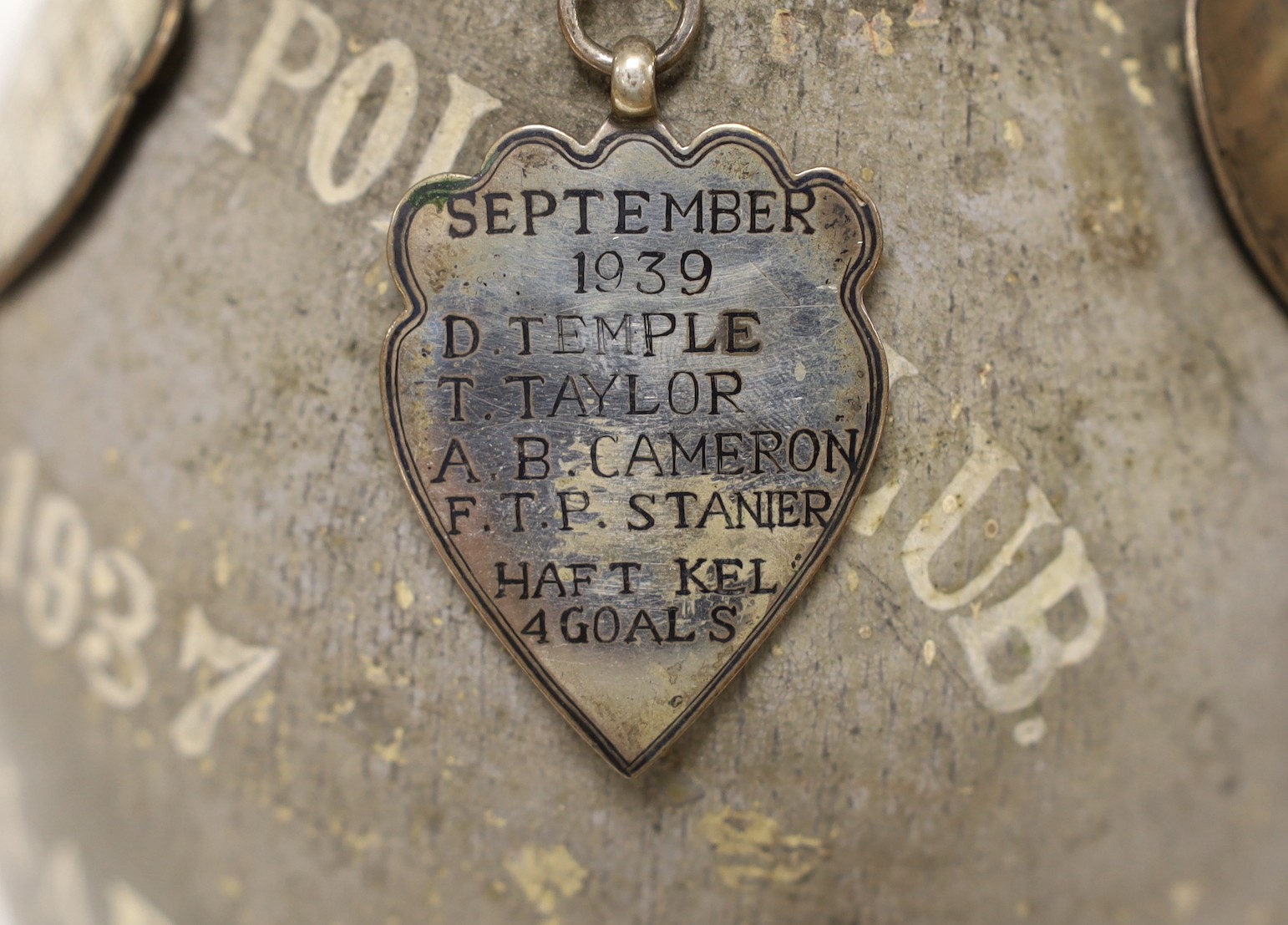 A pottery vase from Fields Polo Club 'The Talk-1-AB Cup', with four white metal badges on a chain engraved with the winners from 1937, 1938, 1939 and 1945, 35cm